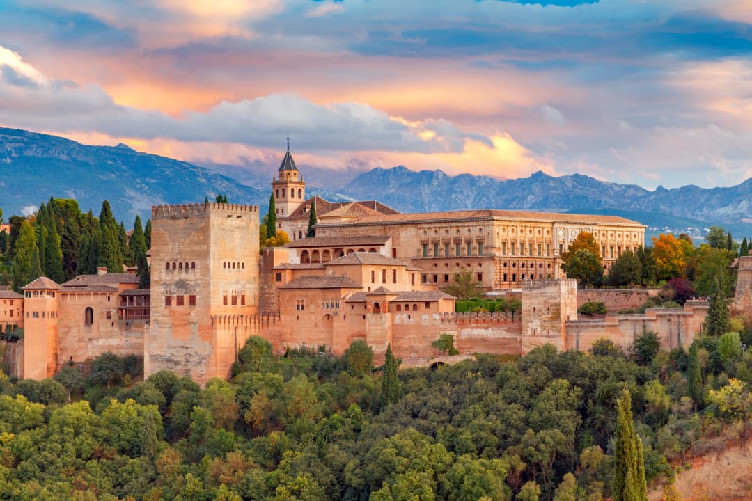 Walls and towers of the fortress of the Alhambra at sunset in Granada. Andalusia. Spain.. Granada. The fortress and palace complex Alhambra.