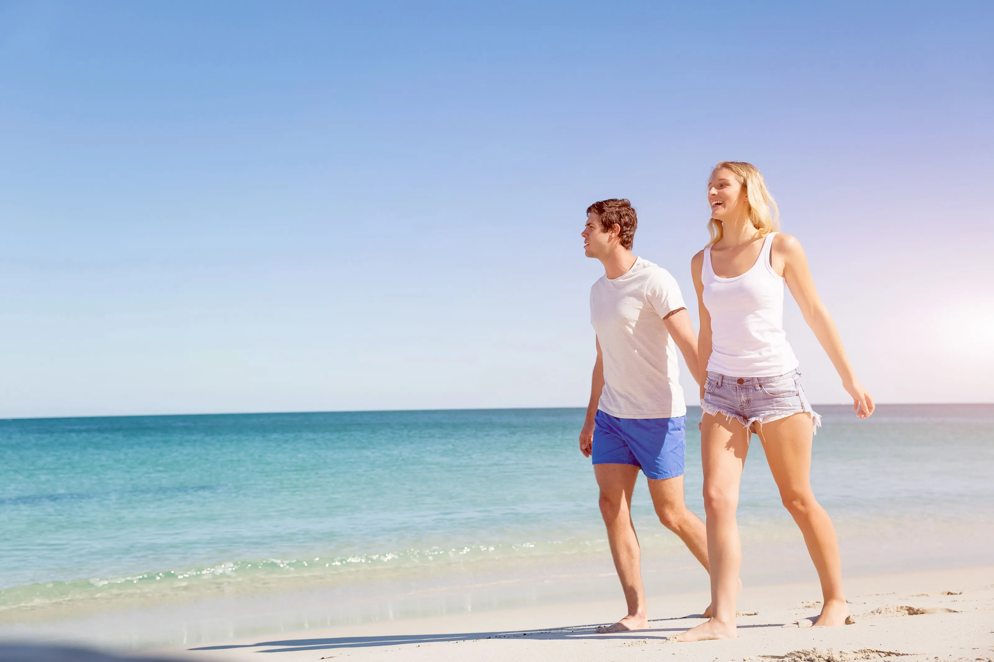 Couple Holding Hands Walking on Carribean Beach